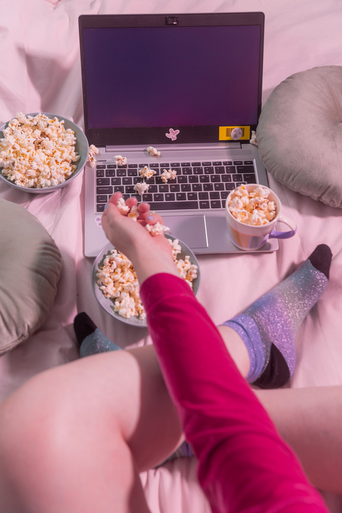 Woman Watching Movie in Laptop with Popcorn